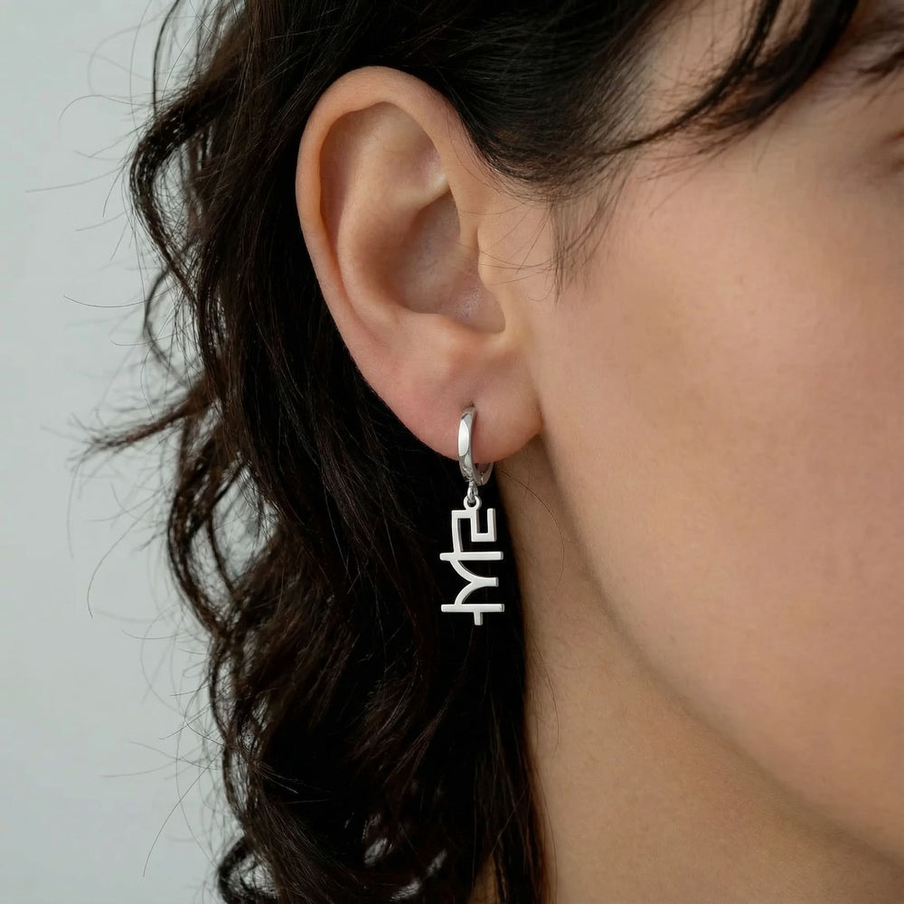 Personalized name drop earrings in Korean in silver finish worn on ear, side profile view