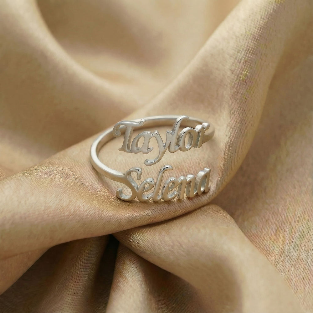 Personalized name ring, one-size in silver finish on beige silk fabric