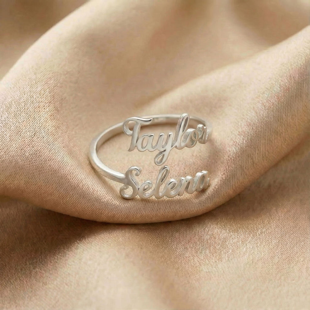 Personalized name ring, one-size in silver finish on beige silk fabric