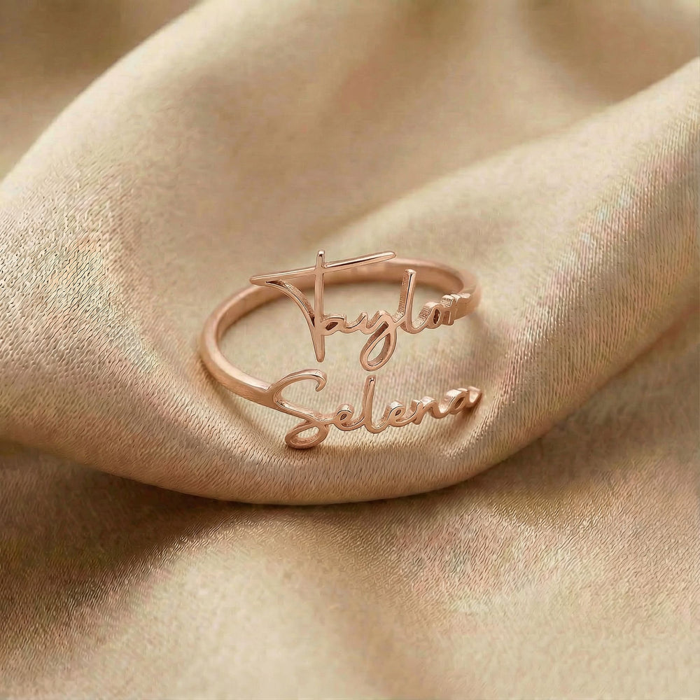Personalized name ring, one-size in rose gold finish on beige silk fabric