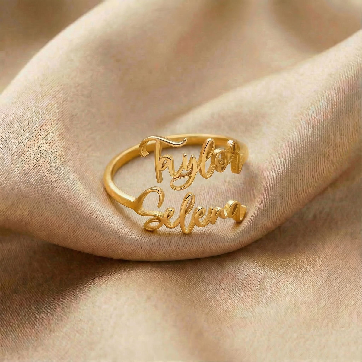 Personalized name ring, one-size in gold finish on beige silk fabric