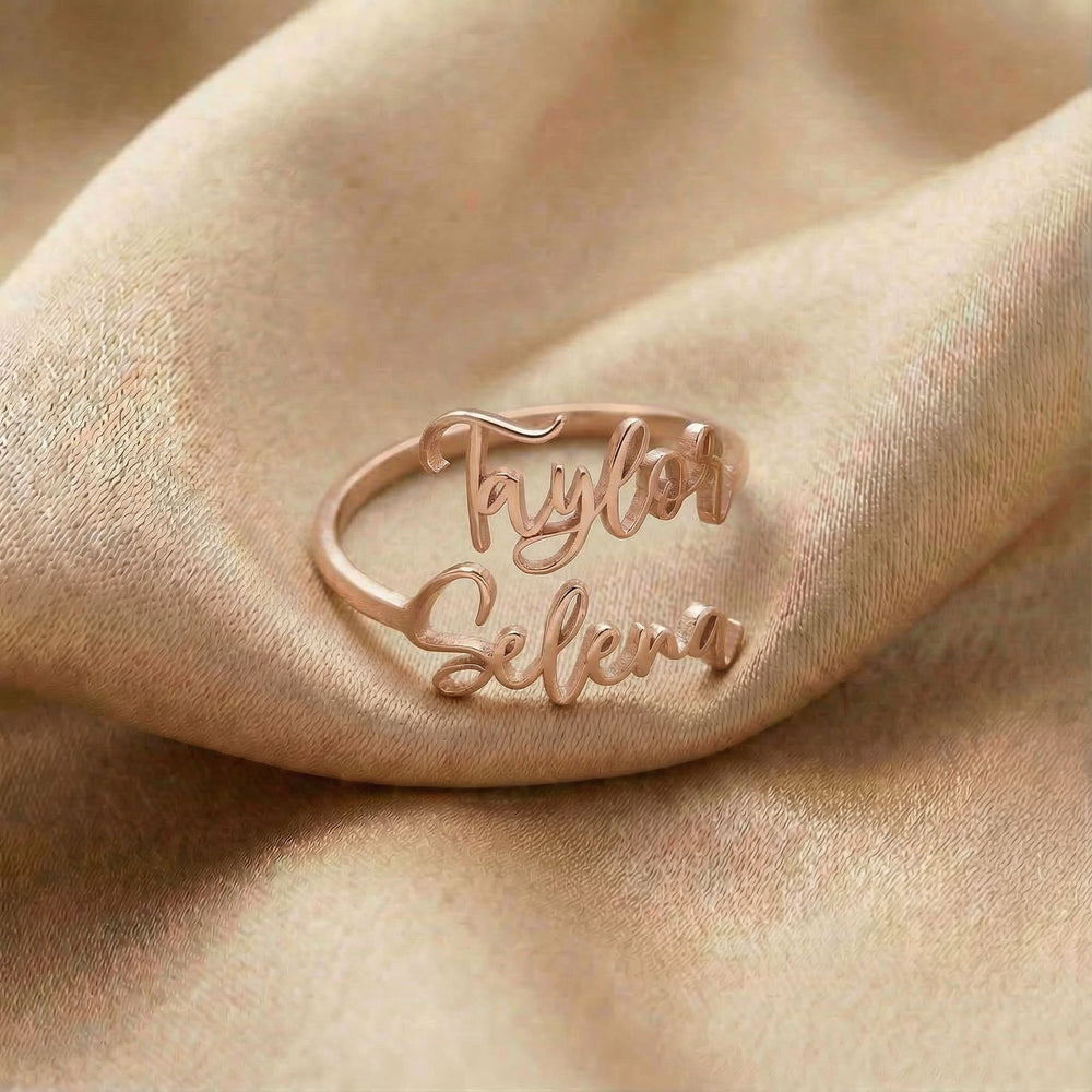 Personalized name ring, one-size in rose gold finish on beige silk fabric