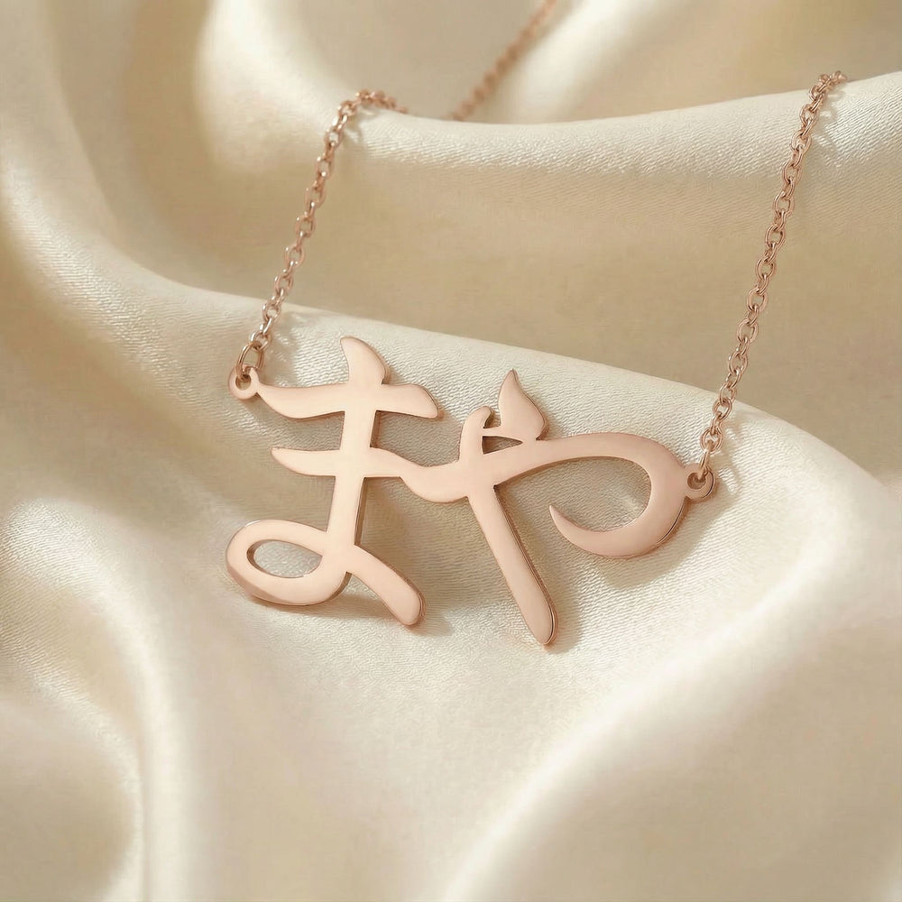 Personalized name necklace in Japanese in rose gold finish on beige silk fabric