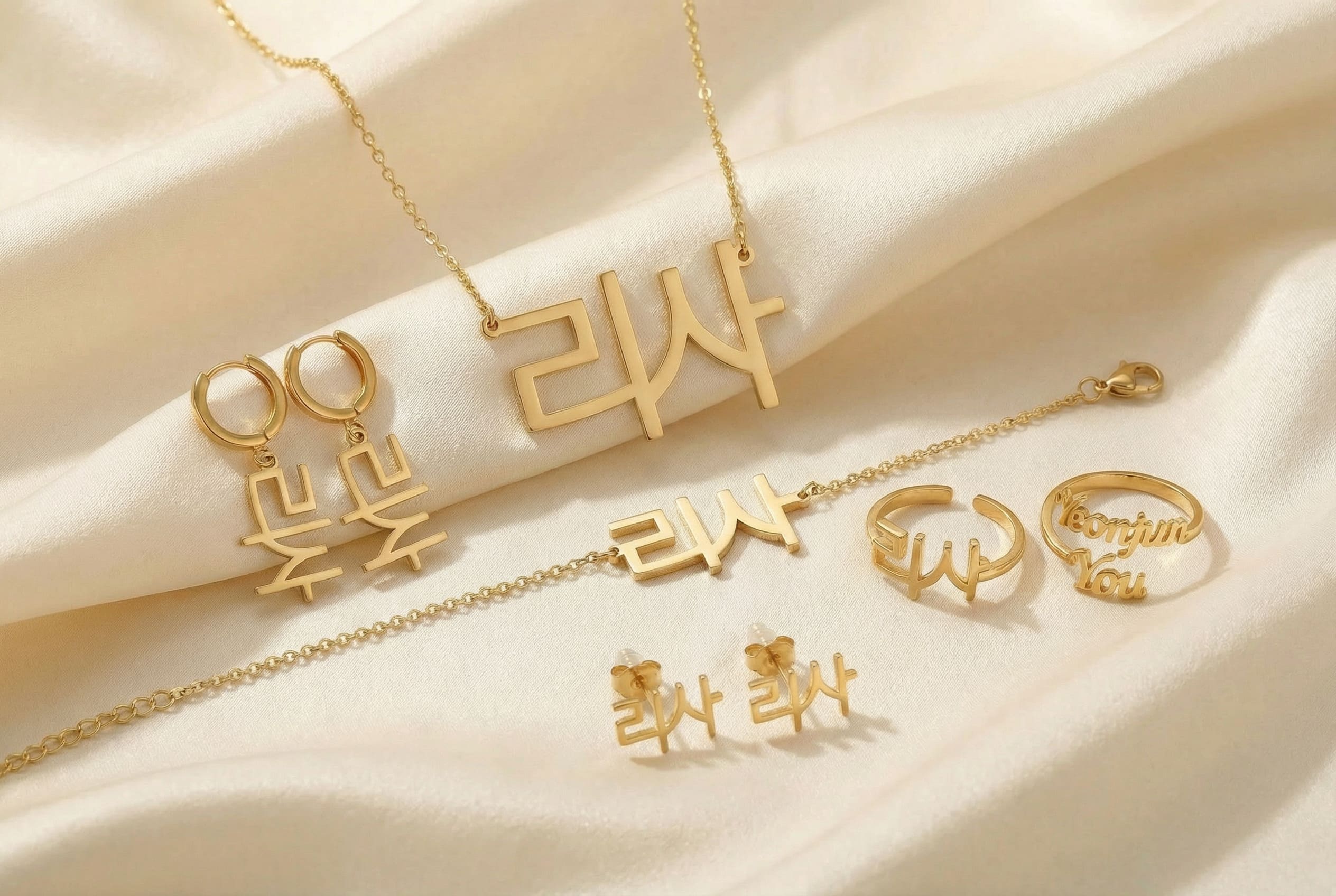 Gold korean jewelry set including necklaces, rings, and pendants on a silk beige fabric