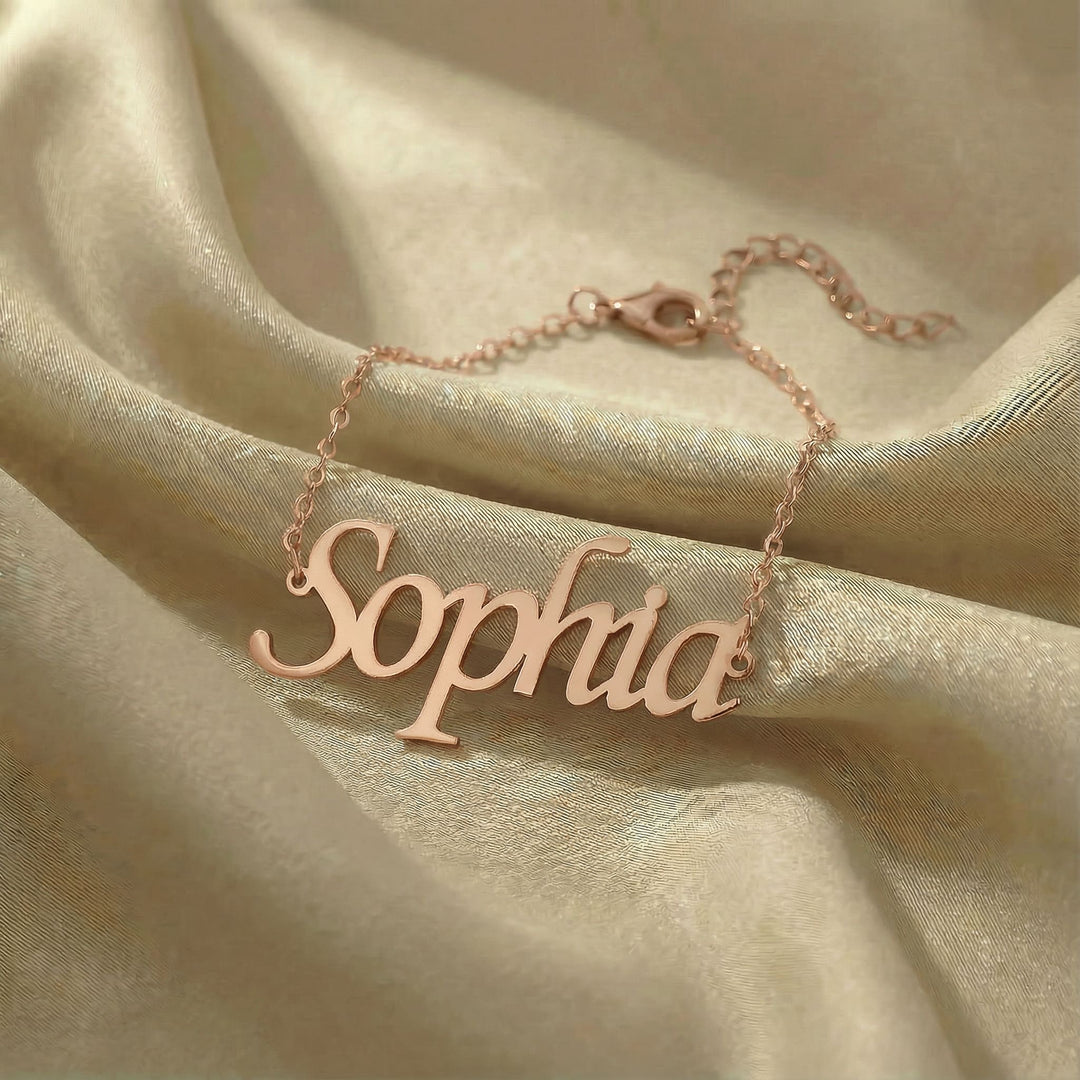 Personalized name bracelet in rose gold finish on beige silk fabric