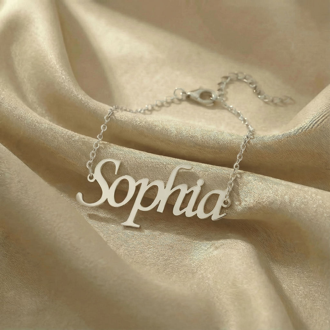 Personalized name bracelet in silver finish on beige silk fabric
