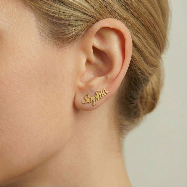 Personalized name ear climber earrings in gold finish worn on ear, side profile view