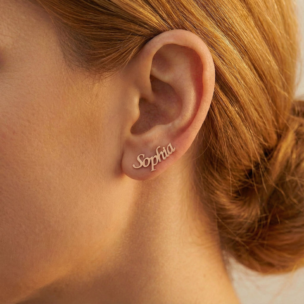 Personalized name ear climber earrings in rose gold finish worn on ear, side profile view