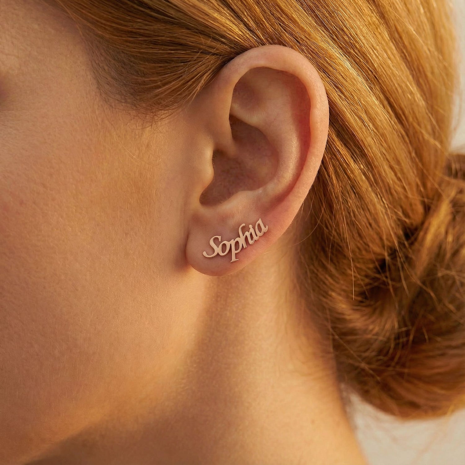 Personalized name ear climber earrings in rose gold finish worn on ear, side profile view