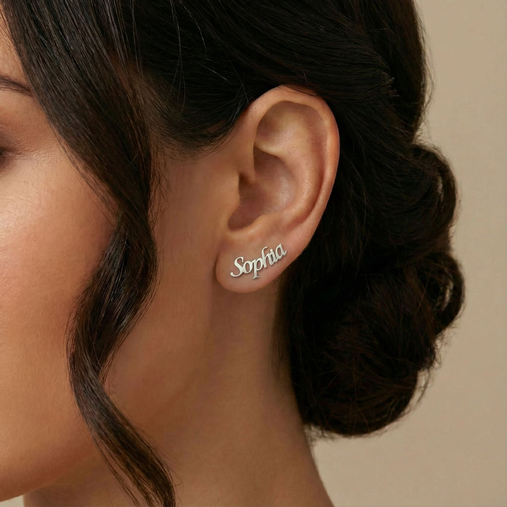 Personalized name ear climber earrings in silver finish worn on ear, side profile view
