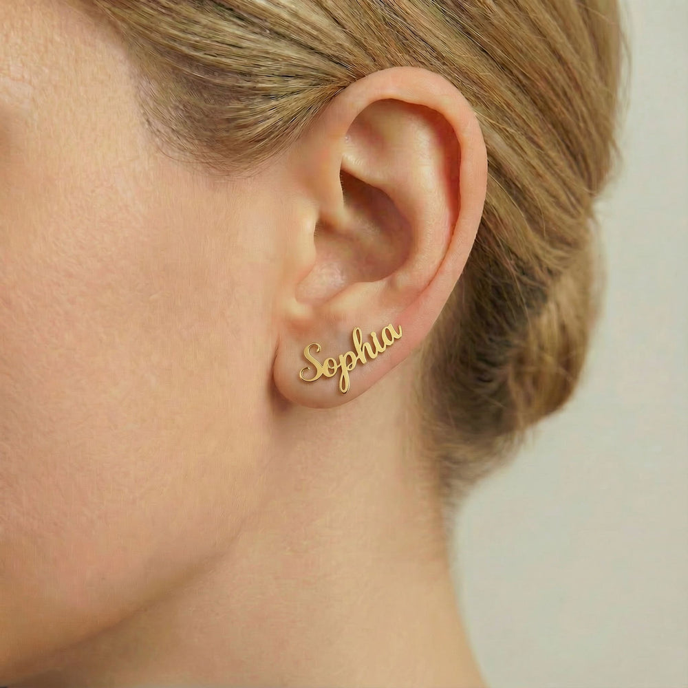Personalized name ear climber earrings in gold finish worn on ear, side profile view