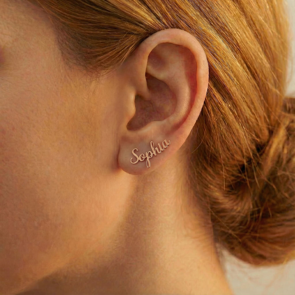 Personalized name ear climber earrings in rose gold finish worn on ear, side profile view