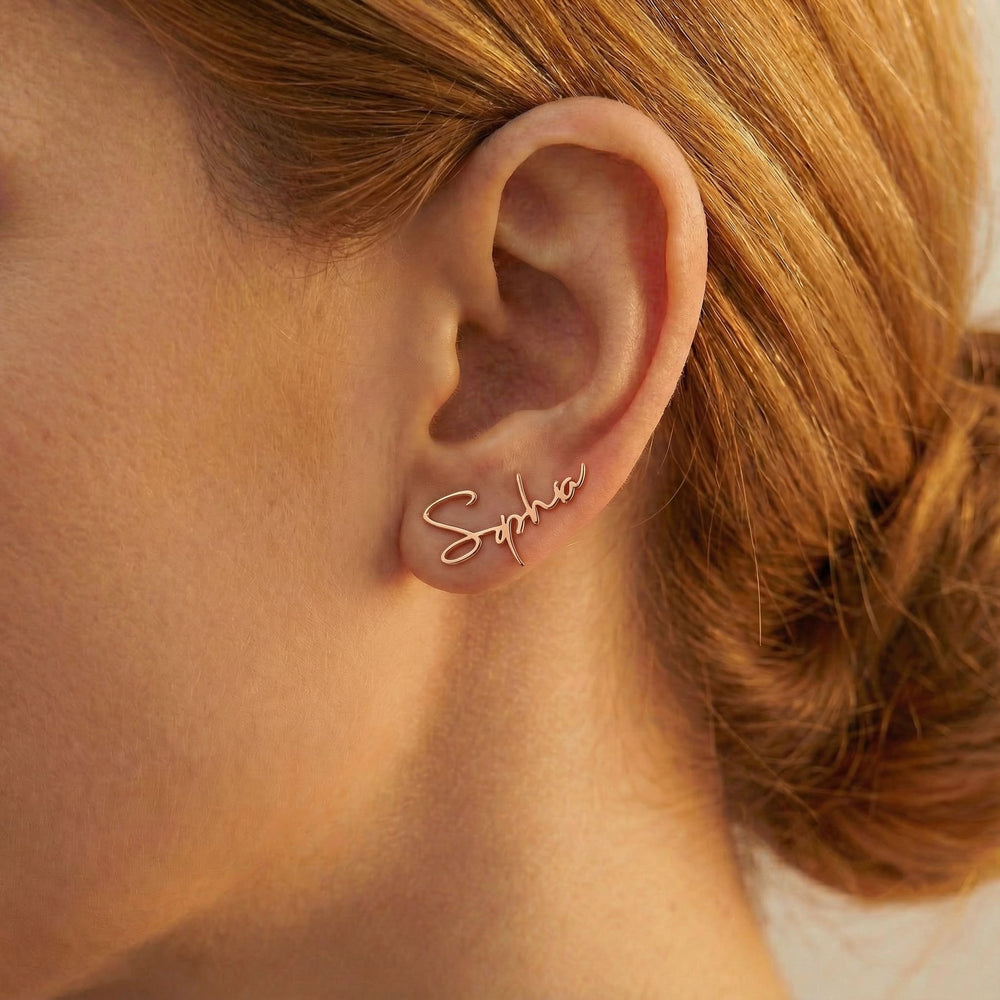 Personalized name ear climber earrings in rose gold finish worn on ear, side profile view