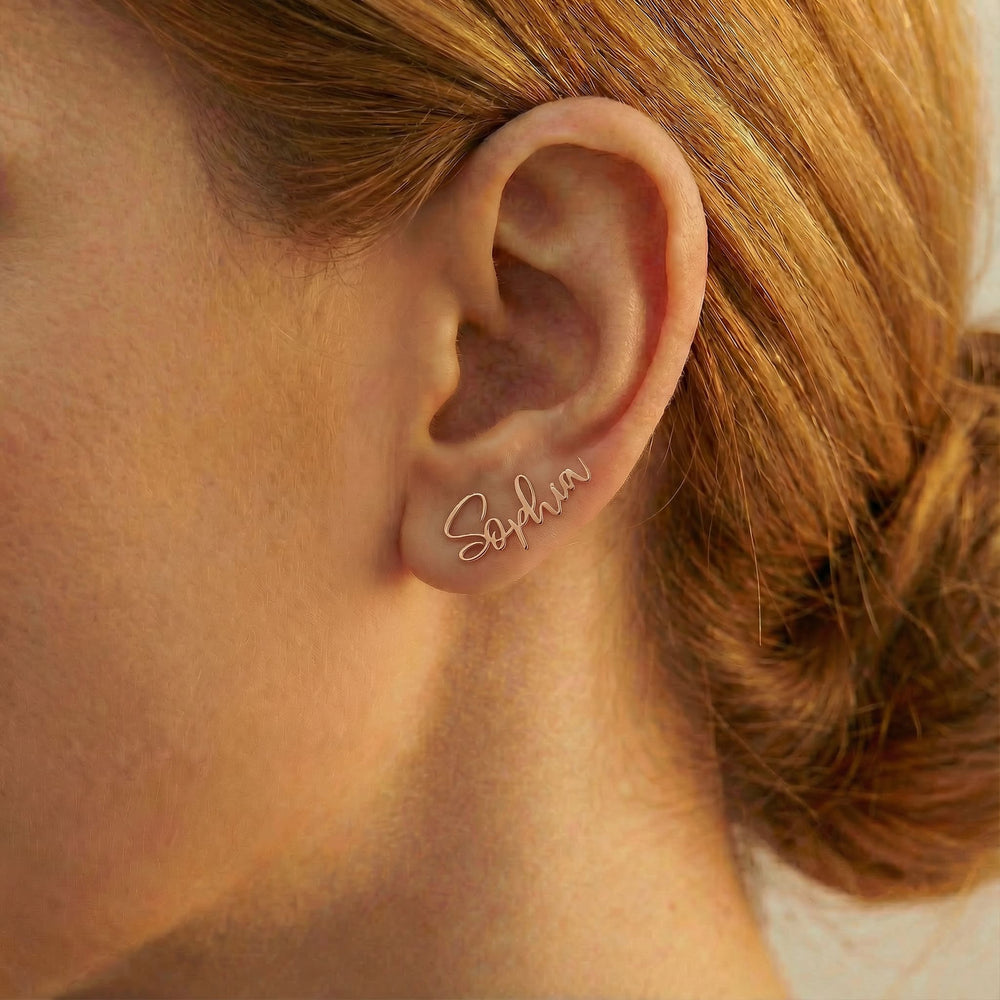 Personalized name ear climber earrings in rose gold finish worn on ear, side profile view