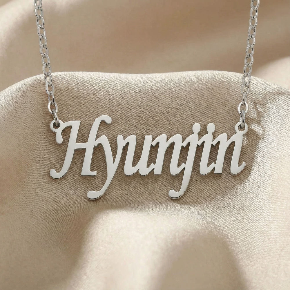 Personalized name necklace in silver finish on beige silk fabric