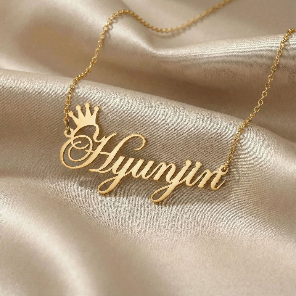 Personalized name necklace in gold finish on beige silk fabric