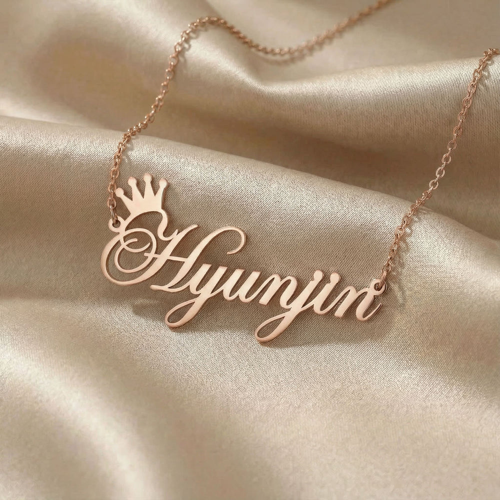Personalized name necklace in rose gold finish on beige silk fabric