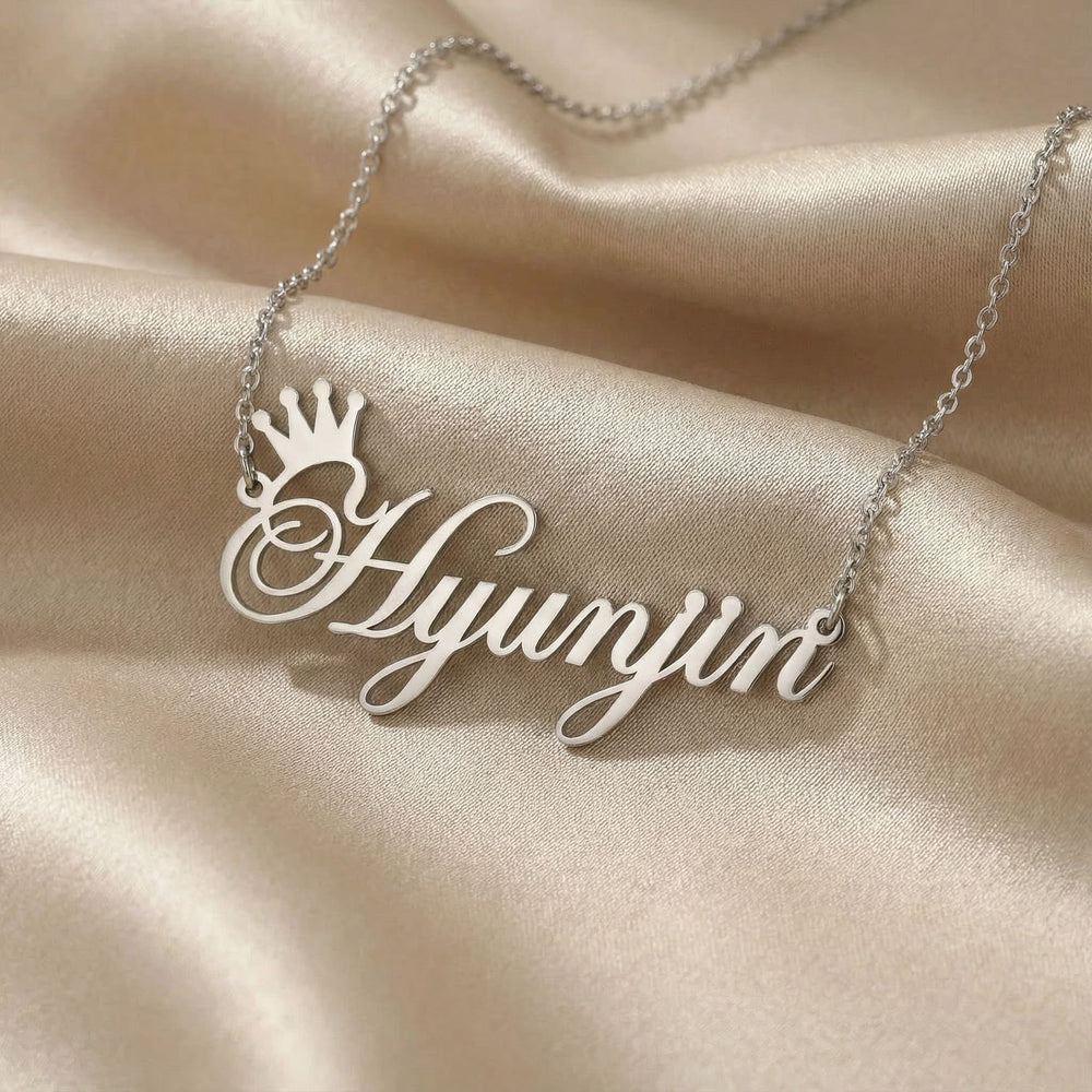 Personalized name necklace in silver finish on beige silk fabric