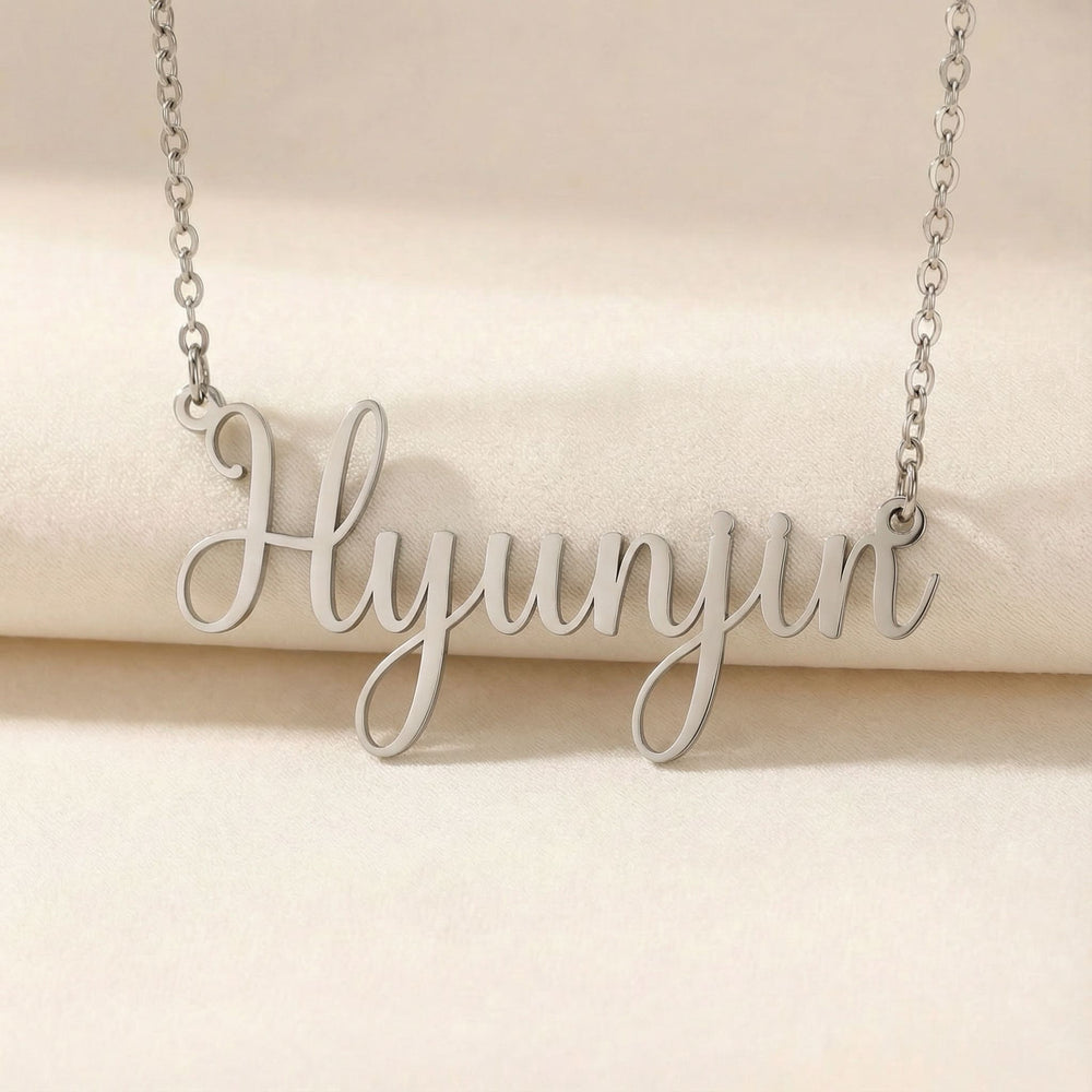 Personalized name necklace in silver finish on beige silk fabric