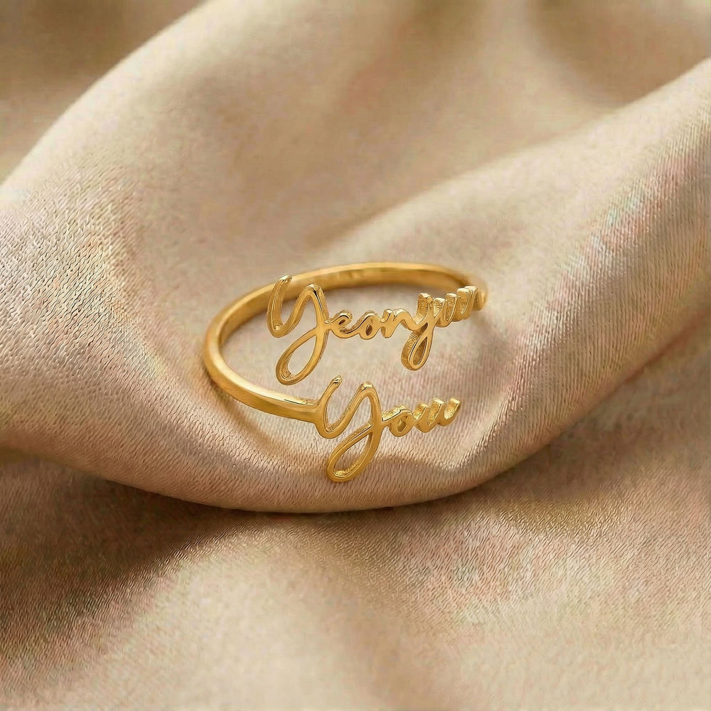 Personalized name ring, one-size in gold finish on beige silk fabric