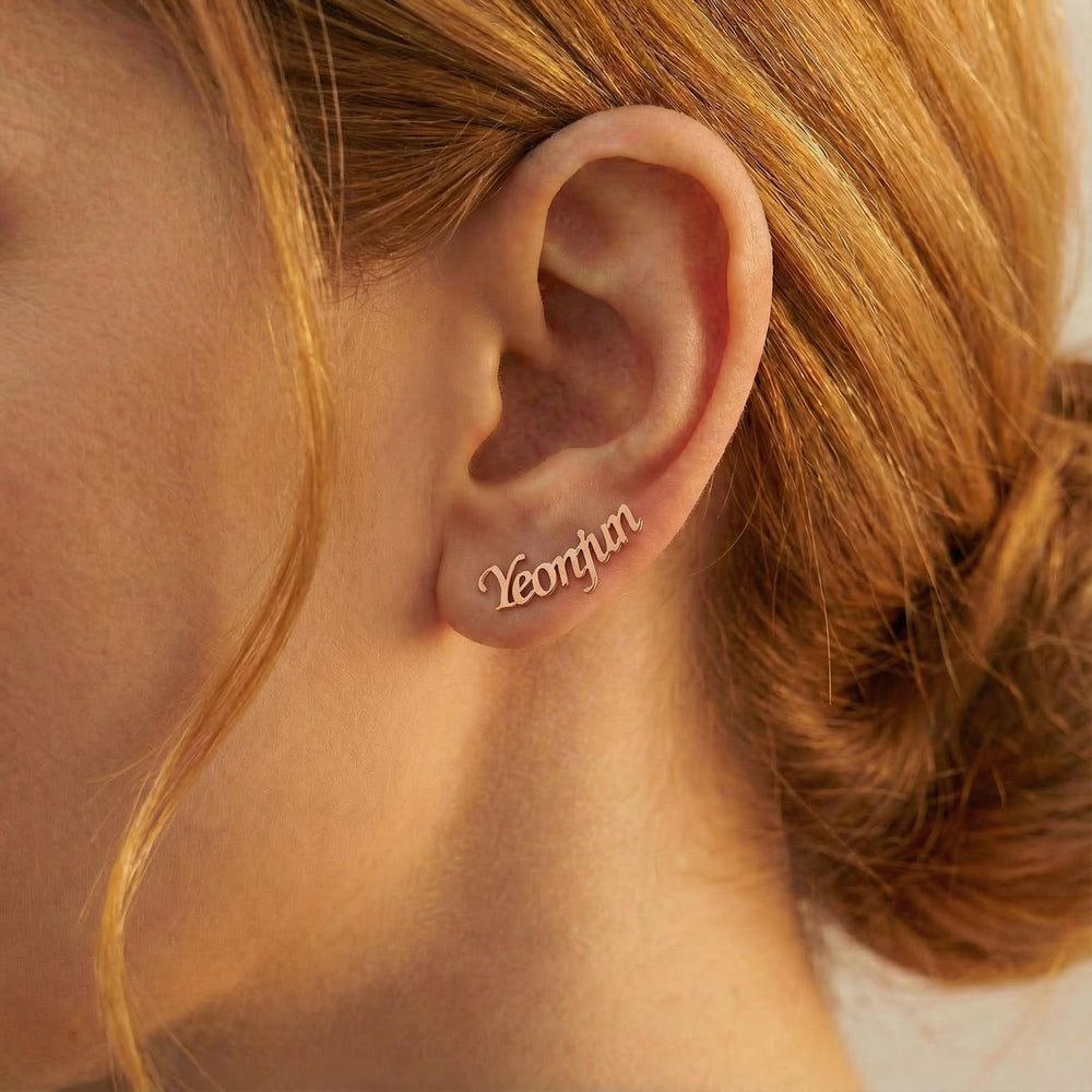 Personalized name ear climber earrings in rose gold finish worn on ear, side profile view