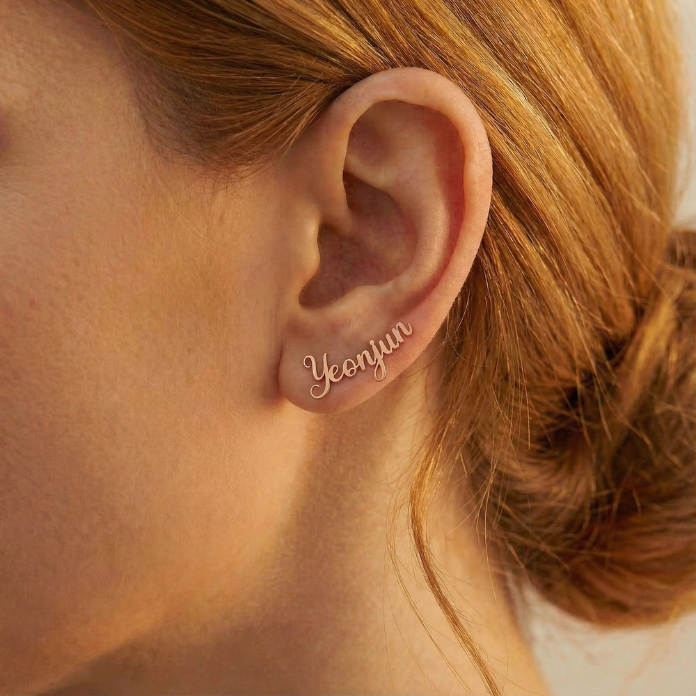 Personalized name ear climber earrings in rose gold finish worn on ear, side profile view