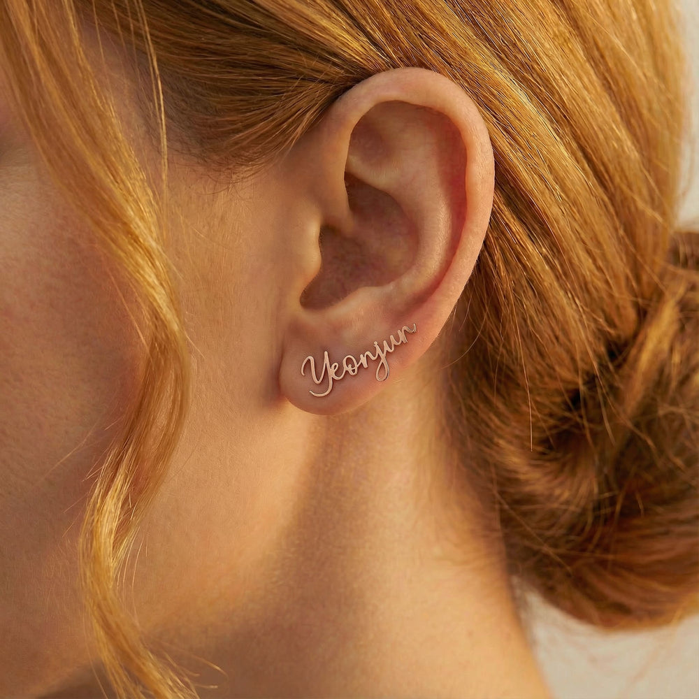 Personalized name ear climber earrings in rose gold finish worn on ear, side profile view