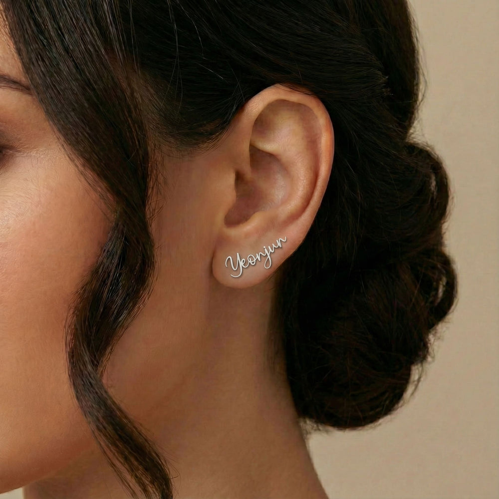 Personalized name ear climber earrings in silver finish worn on ear, side profile view