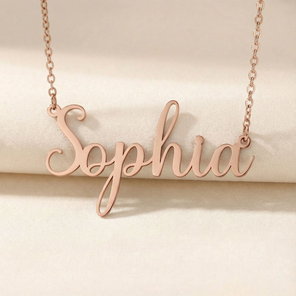 Personalized name necklace in rose gold finish on beige silk fabric