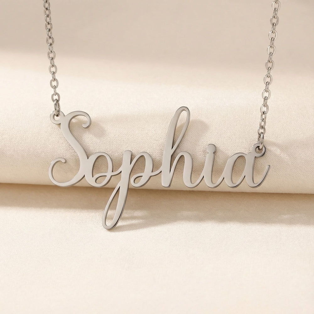 Personalized name necklace in silver finish on beige silk fabric