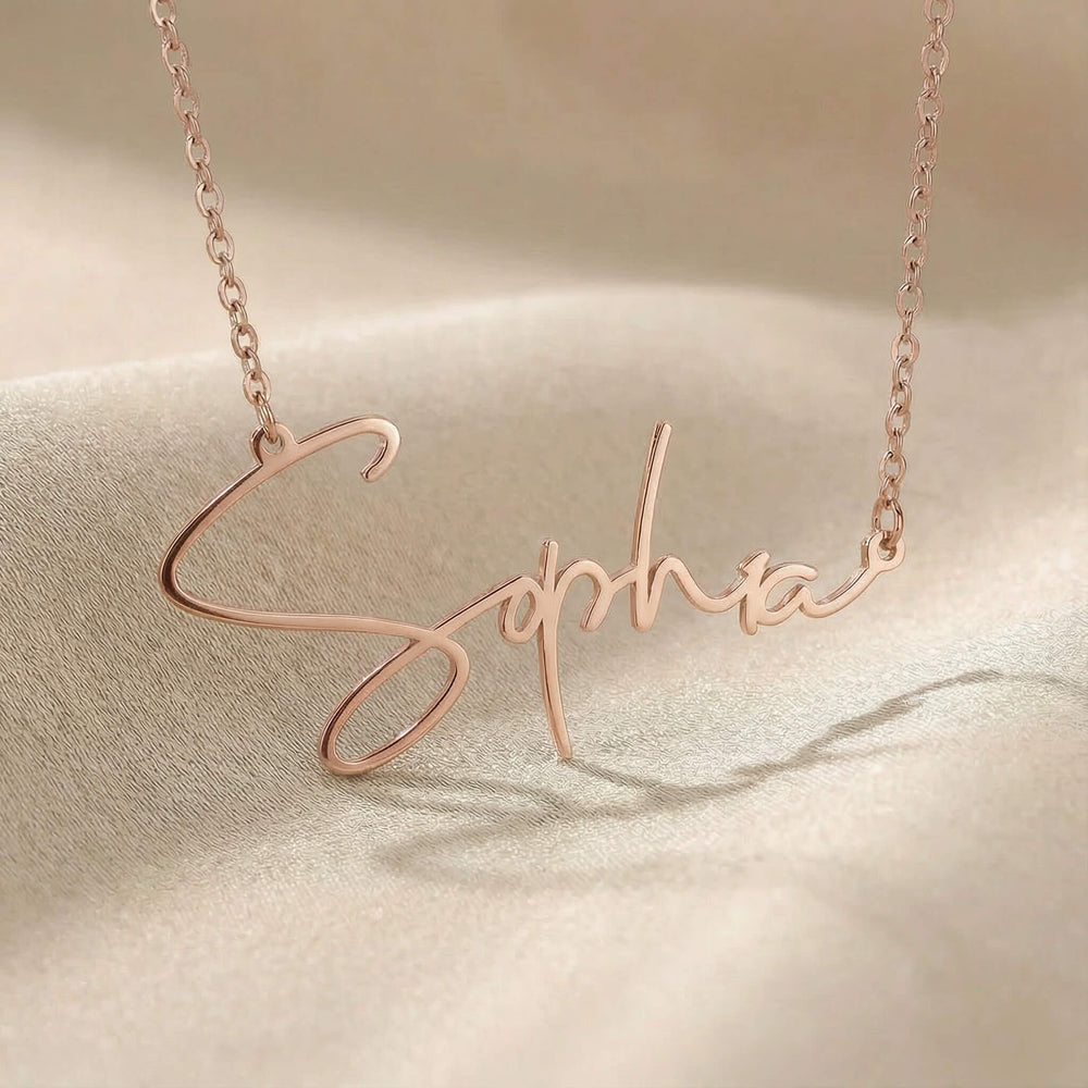 Personalized name necklace in rose gold finish on beige silk fabric