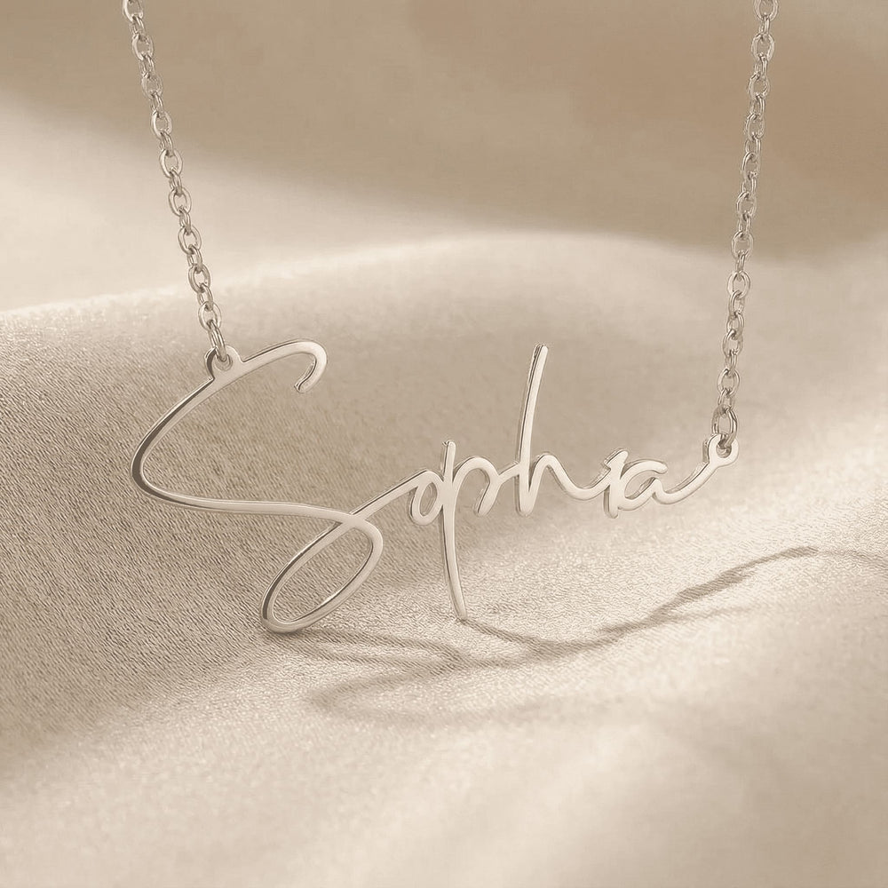 Personalized name necklace in silver finish on beige silk fabric