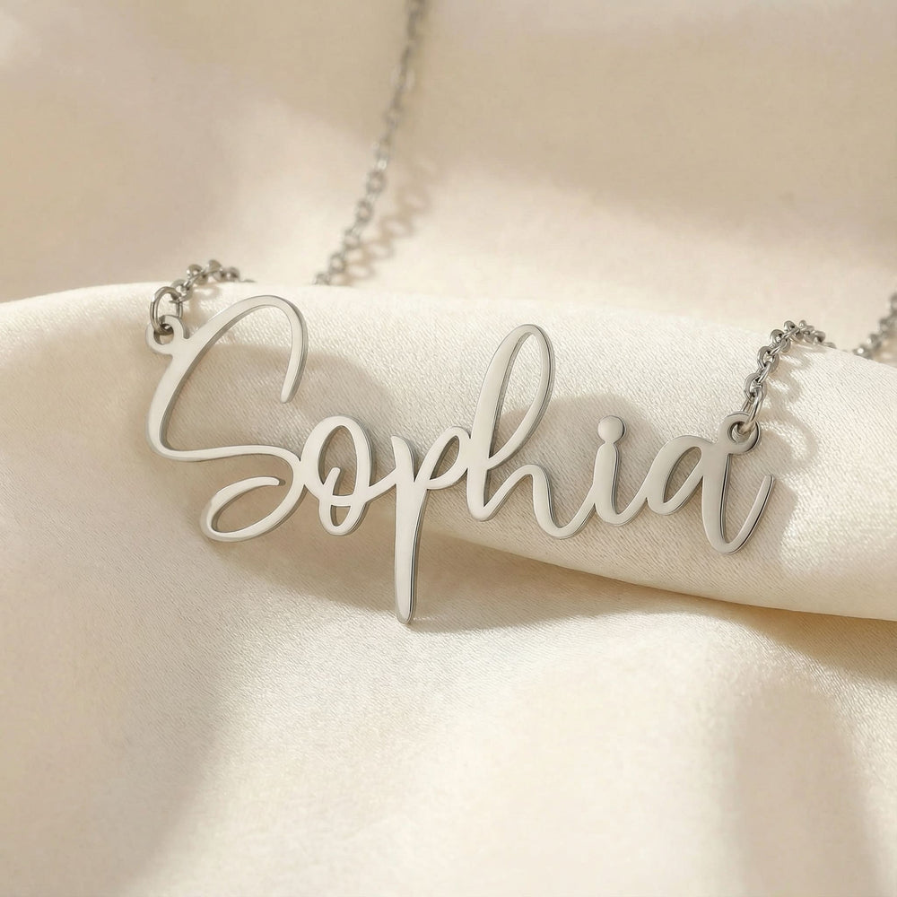 Personalized name necklace in silver finish on beige silk fabric