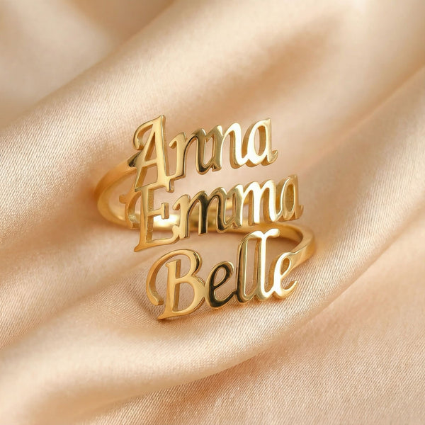 Personalized name ring, one-size in gold finish on beige silk fabric