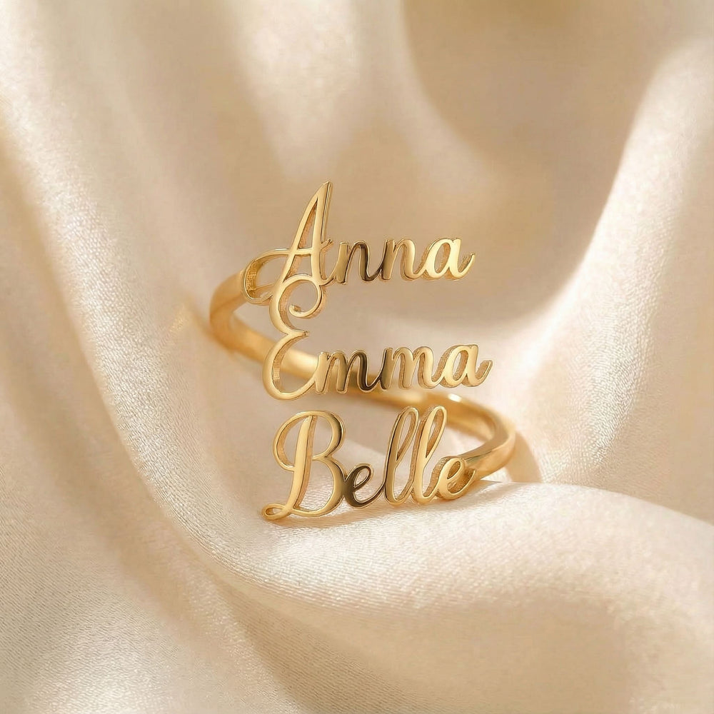 Personalized name ring, one-size in gold finish on beige silk fabric