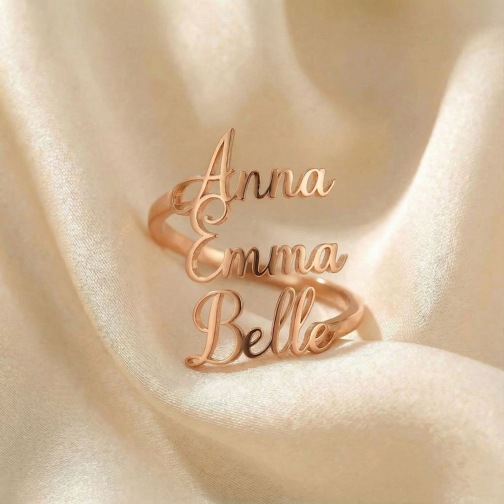 Personalized name ring, one-size in rose gold finish on beige silk fabric