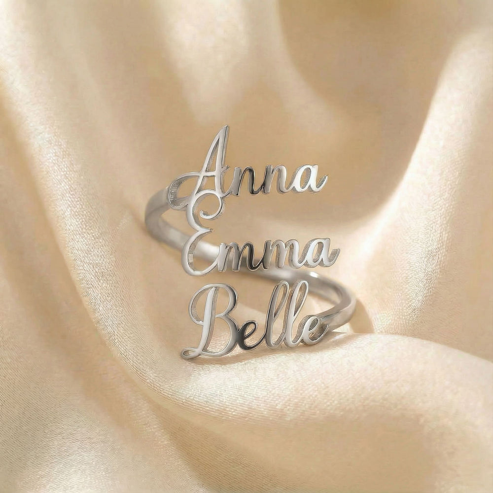 Personalized name ring, one-size in silver finish on beige silk fabric