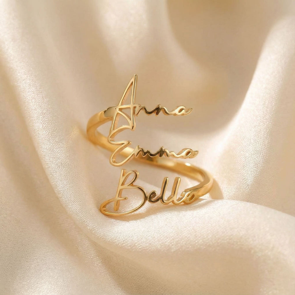 Personalized name ring, one-size in gold finish on beige silk fabric