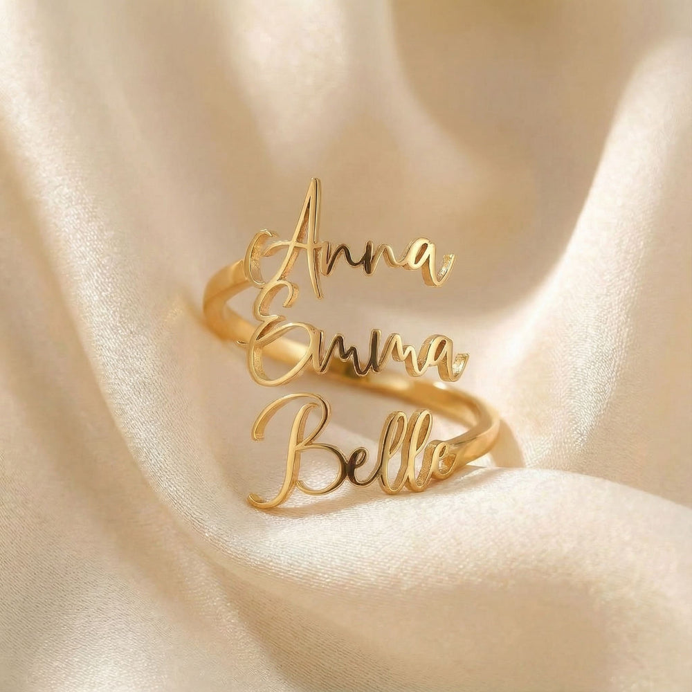 Personalized name ring, one-size in gold finish on beige silk fabric