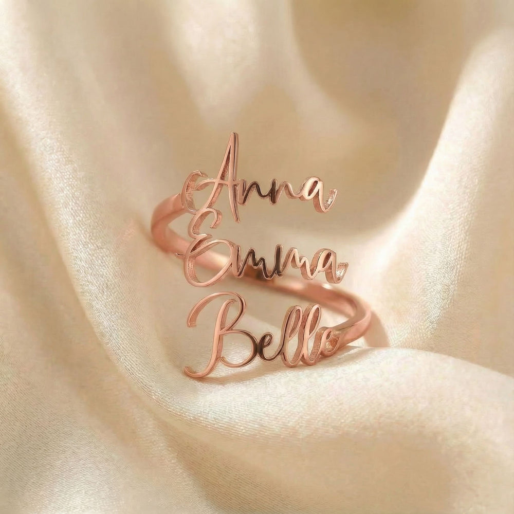 Personalized name ring, one-size in rose gold finish on beige silk fabric