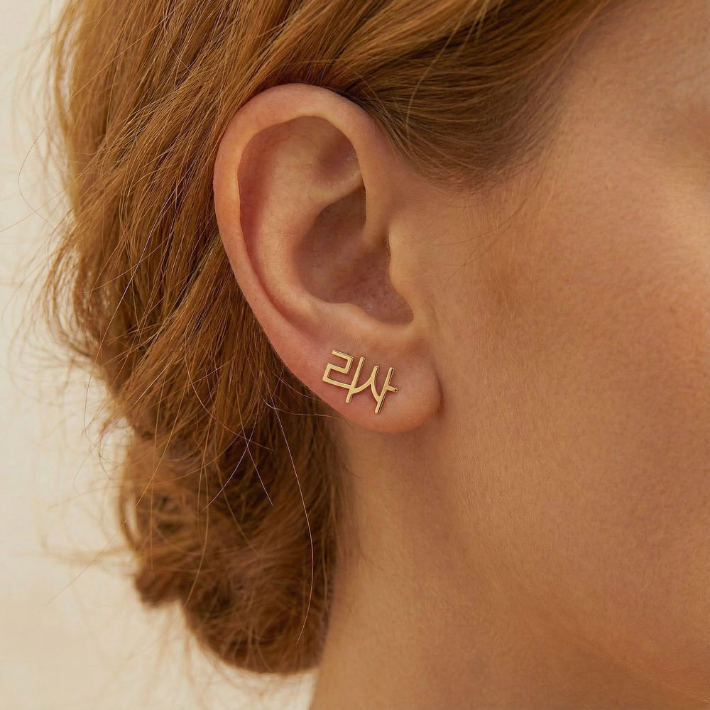 Personalized name ear climber earrings in Korean in gold finish worn on ear, side profile view