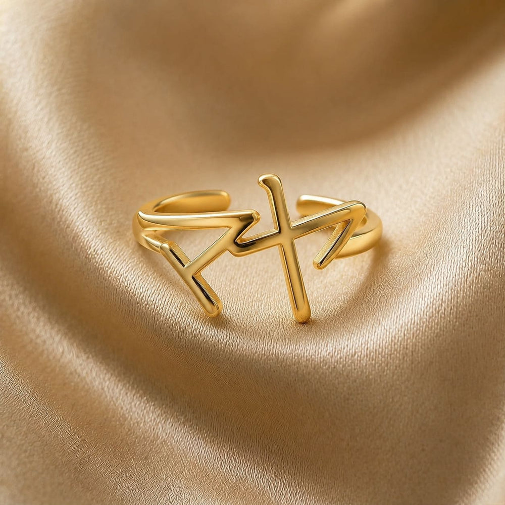 Gold ring with a Japanese Katakana pendant meaning "Maya" on a beige fabric background