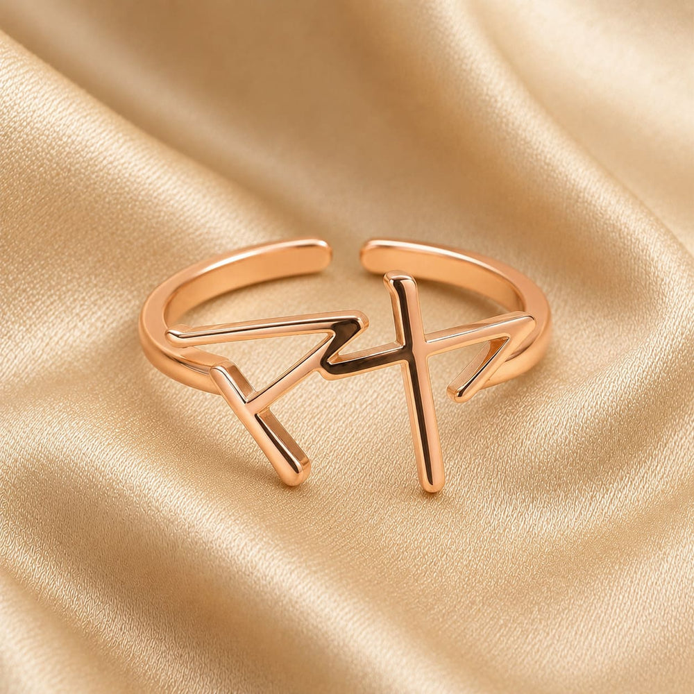 Rose gold ring with Japanese Katakana pendant meaning "Maya" on a beige fabric background
