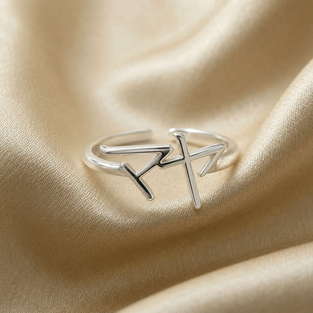 Silver ring with a Japanese Katakana pendant meaning "Maya" on a beige fabric background