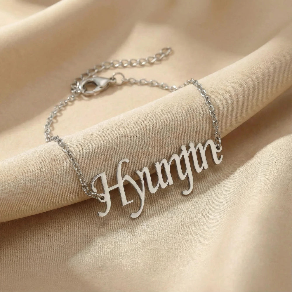 Silver bracelet with 'Hyunjin' pendant on beige fabric
